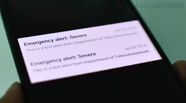 Smartphone displaying a wireless emergency alert notification with the text " Emergency Alert : Severe." The notification states it is a test alert from the Department of Telecommunication (DoT), Govt of India.