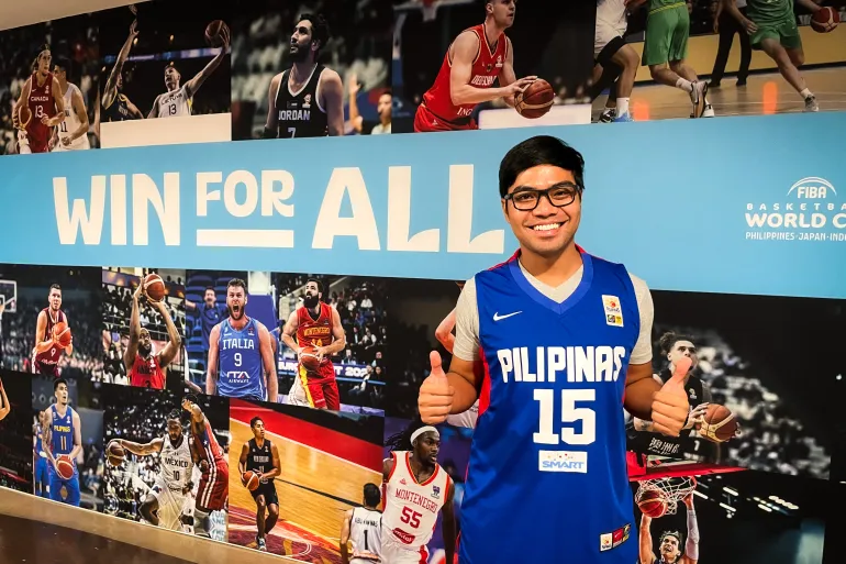 "Excited basketball fans cheering at a stadium during a game in the Philippines, FIBA World Cup 2023 anticipation."