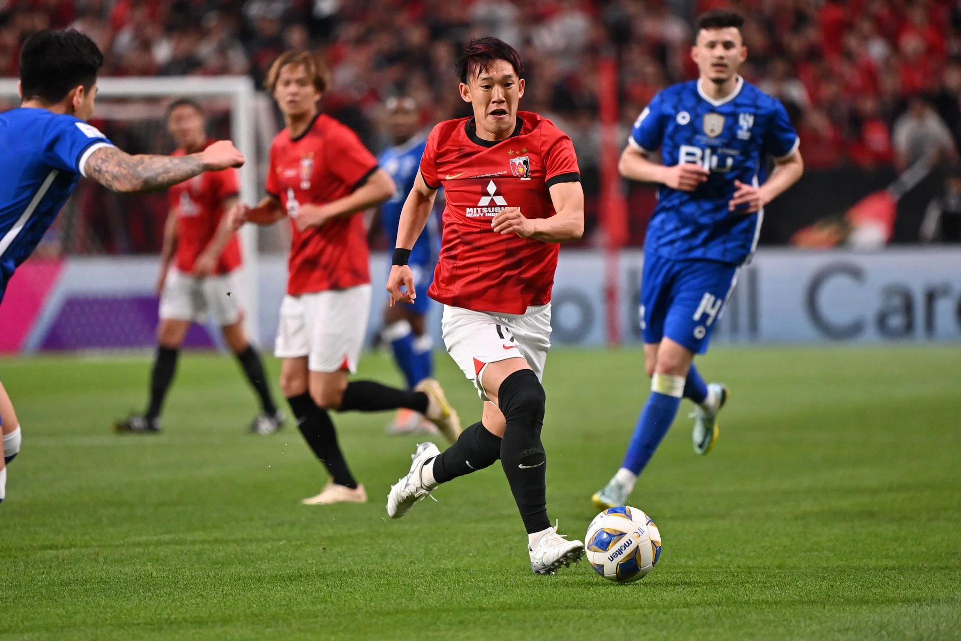 Urawa Red Diamonds vs Lee Man FC match - Players in action on the football pitch"